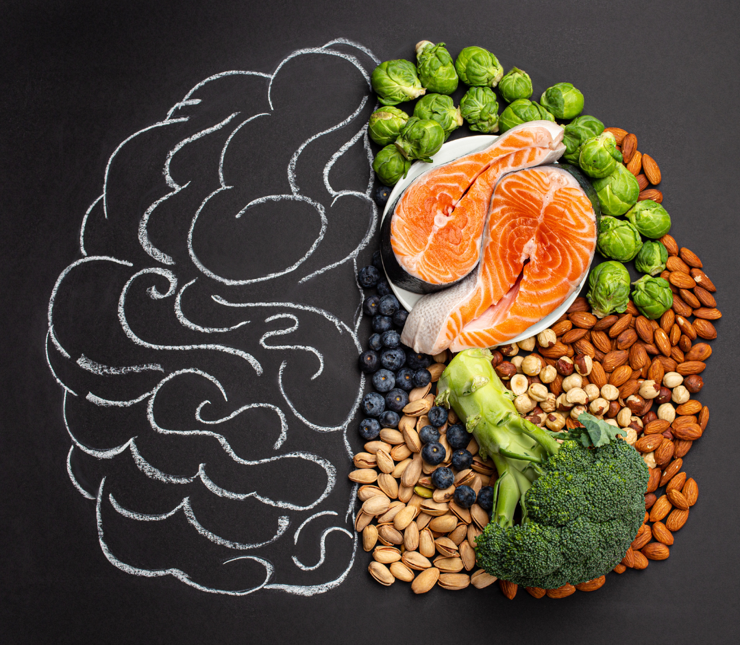 Half brain drawn in chalk on a blackboard and half brain made up for healthy foods<br />
